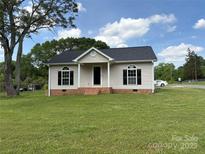 Charming single-story home with black shutters, neutral siding, brick foundation, and inviting front porch at 318 Huffman Rd, Gastonia, NC 28056