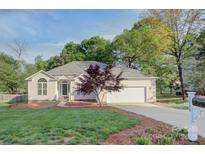 Charming single-story home with well-manicured lawn, mature trees, and attached two car garage at 3226 Chatfield Sw Ln, Concord, NC 28027