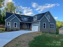 New construction home featuring a modern facade, craftsman details, and inviting entrance, set in a landscaped yard at 3733 Whitney Ne Dr, Hickory, NC 28601
