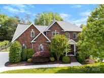 Stunning brick home with lush landscaping and a well-manicured lawn, complete with a new roof at 3748 Tea Olive Rd, Gastonia, NC 28056