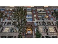 Beautiful brick apartment building with balconies and an arched entryway at 400 N Church St # 413, Charlotte, NC 28202