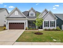 Charming single Gathering home with a two car garage and manicured front yard with lush green grass at 471 Lucky Nw Dr, Concord, NC 28027
