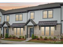 Attractive brick and vinyl townhome with covered entry and landscaped yard at 5712 Runnel Way, Charlotte, NC 28215