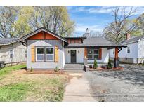 Charming single-story home with gray siding, orange trim, and a welcoming front porch at 908 W Airline Ave, Gastonia, NC 28052