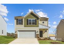 Charming two-story home featuring a two-car garage and well-manicured lawn at 121 Dorian Pl, Troutman, NC 28166