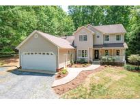 Charming two-story home with an attached two car garage and welcoming front porch at 122 Roxboro Ct # 286, Mount Gilead, NC 27306