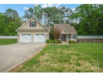 Charming home featuring an attached two-car garage, well-maintained lawn and traditional design elements at 2646 N Olivers Cross Rd, Newton, NC 28658