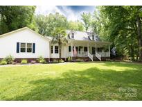 Charming home with a large front yard, white siding, and inviting front porch at 432 Partridge Pl, York, SC 29745
