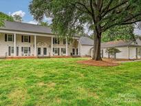 Charming townhome featuring a spacious front yard and classic colonial architectural design at 7004 Quail Hill Rd, Charlotte, NC 28210