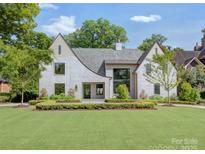 Stunning exterior view of a two-story home with manicured lawn and lush landscaping at 1919 Shoreham Dr, Charlotte, NC 28211