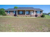 Charming brick home featuring a welcoming front porch and well-maintained landscaping at 118 Sir Gregory Dr, Shelby, NC 28152