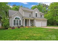 Charming two-story home featuring gray siding, well-manicured lawn, and a two-car garage at 121 Northampton Dr, Mooresville, NC 28117