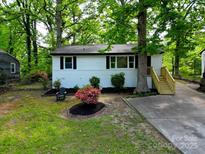 Charming home featuring a landscaped front yard and a newly constructed wooden staircase at 1750 Oak Valley Dr, Gastonia, NC 28054