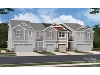 Charming townhome featuring a two-car garage and a beautifully designed facade with gray siding and stone accents at 2017 Vinyasa Ln # Sts-42, Charlotte, NC 28215