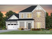 Charming two-story home featuring a brick facade, gray siding, a two-car garage, and a well-manicured lawn at 2200 Riverbend Ave # 19, Monroe, NC 28110