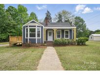 Charming home with navy blue siding, a front porch, and a well-maintained lawn at 410 E 17Th St, Kannapolis, NC 28083