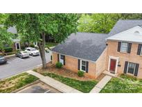 Brick exterior of townhome with neat landscaping and a convenient parking area at 8325 Knights Bridge Rd, Charlotte, NC 28210