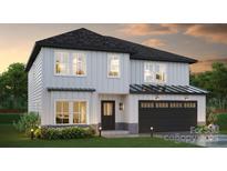 Charming two-story home featuring white siding, a black roof, and an attached two-car garage at Lot 6 Rocky River Crossing Rd, Harrisburg, NC 28075