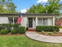 Charming single-story home featuring a well-manicured lawn, classic brick facade, and an inviting front entrance at 1714 Edgewater Dr, Charlotte, NC 28210