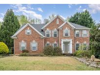 Charming brick two-story home with manicured lawn, symmetrical design and welcoming entrance at 2620 Shady Reach Ln, Charlotte, NC 28214