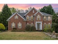 Beautiful brick two-story home featuring a manicured lawn and a classic architectural design at 2620 Shady Reach Ln, Charlotte, NC 28214