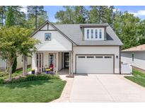 Charming home featuring a two-car garage, well-manicured lawn, and a inviting front porch at 4902 Looking Glass Trl, Denver, NC 28037