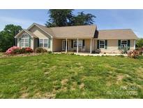 Charming single story home with well maintained lawn and a welcoming front porch at 6454 Sain Milling Rd, Vale, NC 28168