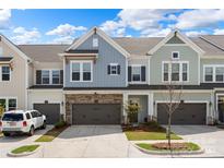 Charming townhome exterior featuring multi-tone facade, stone accents, and attached two-car garages at 8107 Houser St, Cornelius, NC 28031
