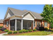 Attractive single story brick house with screened in porch and manicured lawn and landscaping at 8473 Bing Cherry Dr, Denver, NC 28037