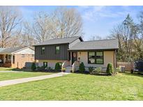 Charming two-story home with a well-manicured lawn and inviting walkway at 1628 Starbrook Dr, Charlotte, NC 28210