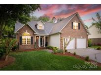 Charming brick home featuring a two-car garage, manicured lawn, and inviting entrance, perfect for suburban living at 2478 23Rd Ne St, Hickory, NC 28601