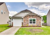 Charming single-story home with a stone facade, attached garage, and freshly landscaped front yard at 2810 Berry Creek Rd, Charlotte, NC 28214