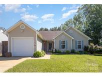 Charming single-story home with a well-maintained lawn, inviting entrance, and a convenient attached garage at 5804 Crosswinds Ct, Indian Trail, NC 28079