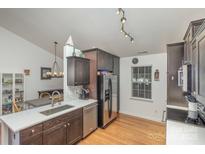 Well-lit kitchen features stainless steel appliances, dark cabinets, and a modern countertop at 5804 Crosswinds Ct, Indian Trail, NC 28079