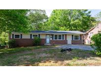 Charming one-story home with brick accents, blue shutters, and a well-maintained front yard at 634 7Th Avenue Se Pl, Hickory, NC 28602