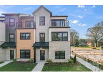 Modern townhome featuring varied exterior materials, multiple balconies, and manicured landscaping at 722 Falling Oak Aly # 20, Huntersville, NC 28078