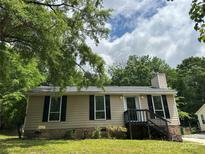 Charming single-story home featuring neutral siding, black shutters, and well-maintained landscaping at 8000 Tiburon Cir, Charlotte, NC 28215