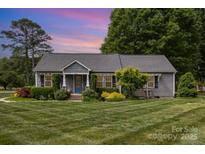 Charming home with well-maintained lawn, mature trees and established landscaping at 878 Cold Springs Rd, Concord, NC 28025