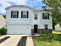 Charming two-story home boasts a two-car garage, black shutters and stone accents at 12713 Frank Wiley Ln, Charlotte, NC 28278