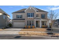 Charming two-story home with brick and siding, a two-car garage, and a well-maintained front yard at 14004 Fiery Mist Way, Huntersville, NC 28078