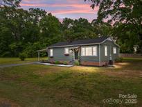 Charming single-story home with tidy landscaping, flower boxes and a covered porch at 322 Corriher Heights Ave, China Grove, NC 28023