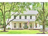 Charming two-story home with a well-manicured lawn, white siding, and a welcoming front porch at 611 Heathermoor Ct, Charlotte, NC 28209