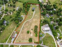 Expansive property featuring a large home, open land, and surrounding greenery, all within a defined boundary at 6218 Indian Trail Fairview Rd, Indian Trail, NC 28079