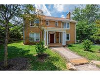 Charming brick two-story home with red front door and well-maintained front yard at 625 2Nd Ne St, Hickory, NC 28601