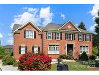 Stunning brick home with lush landscaping, manicured lawn and black shutters at 11917 Chevis Ct, Charlotte, NC 28277
