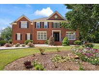 Inviting brick home with manicured lawn and garden at 11917 Chevis Ct, Charlotte, NC 28277