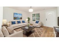 Bright living room with a decorative rug, neutral furniture, and stylish accents at 1620 Crandon Dr, Charlotte, NC 28216