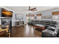 Large living room with hardwood floors, fireplace, and comfortable seating at 1948 Winpole Ln, Charlotte, NC 28273