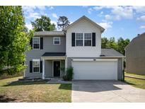 Charming two-story home with gray siding, white accents, and a two-car garage at 2046 E Park Dr, Lancaster, SC 29720