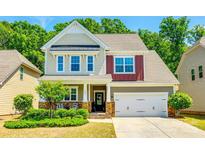 Charming two-story home with a manicured lawn and attached two-car garage at 3005 Oakmere Rd, Waxhaw, NC 28173